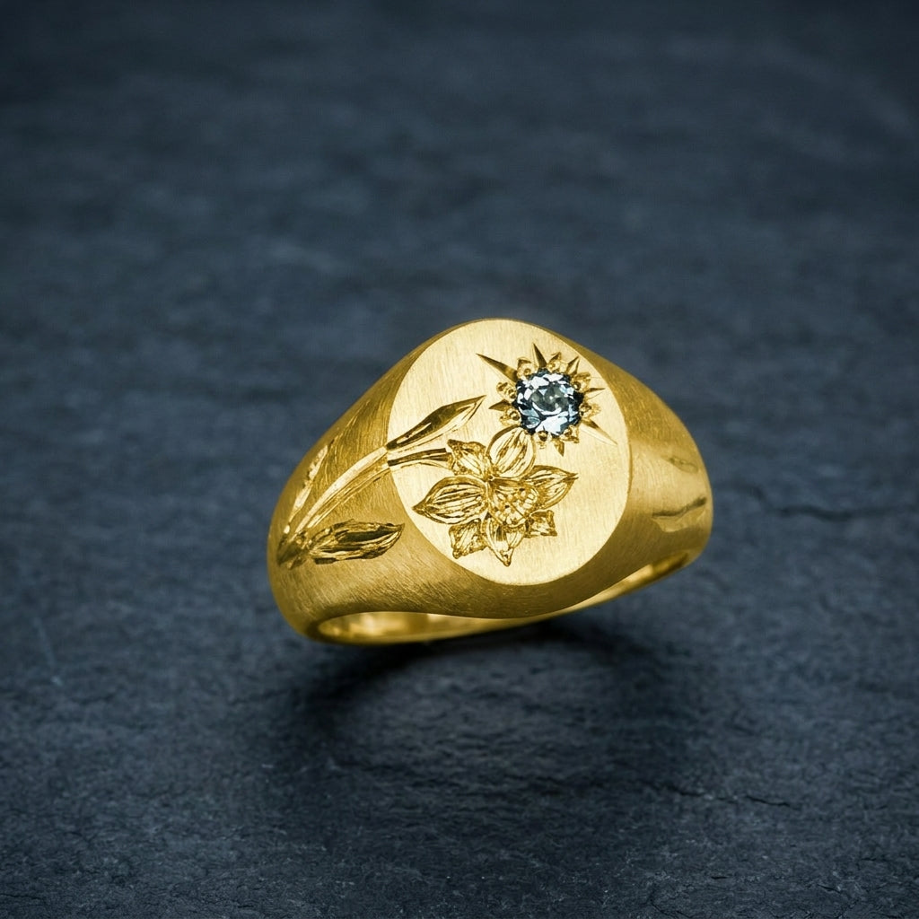 Hand engraved Daffodil signet ring in 18k gold on slate by Mier Theo
