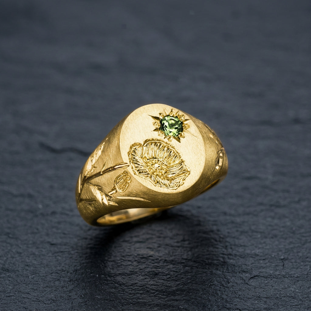 Hand engraved Poppy signet ring in 18k gold on slate by Mier Theo