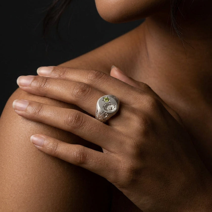Hand engraved Poppy signet ring in 940 Silver on hand by Mier Theo