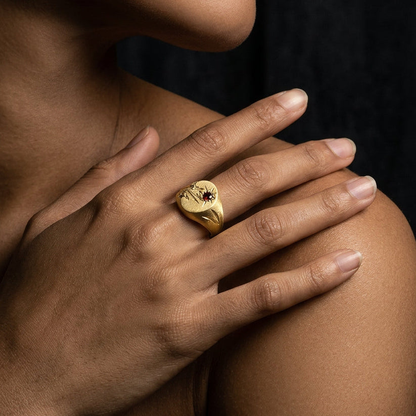 Hand engraved Snowdrop signet ring in 18k gold on hand by Mier Theo