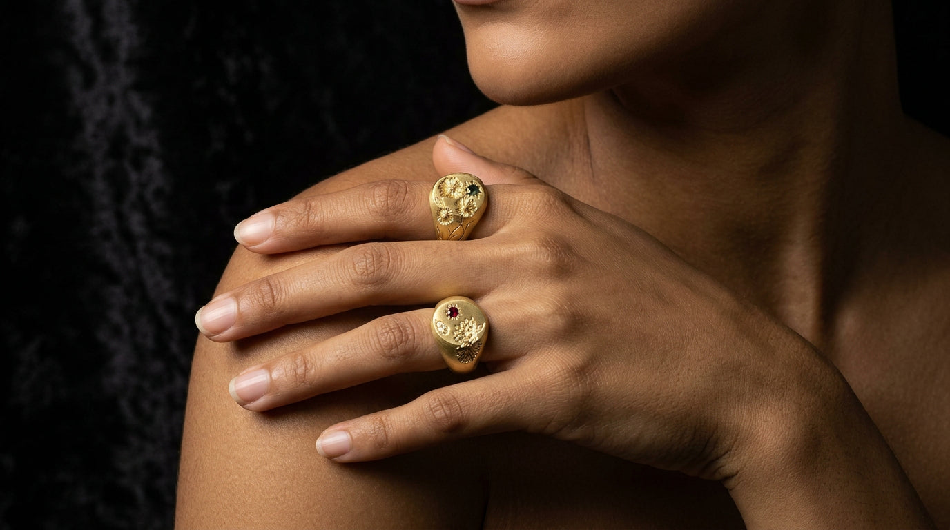 Hand engraved Cosmos & Water Lily signet rings in 18k gold on hand by Mier Theo