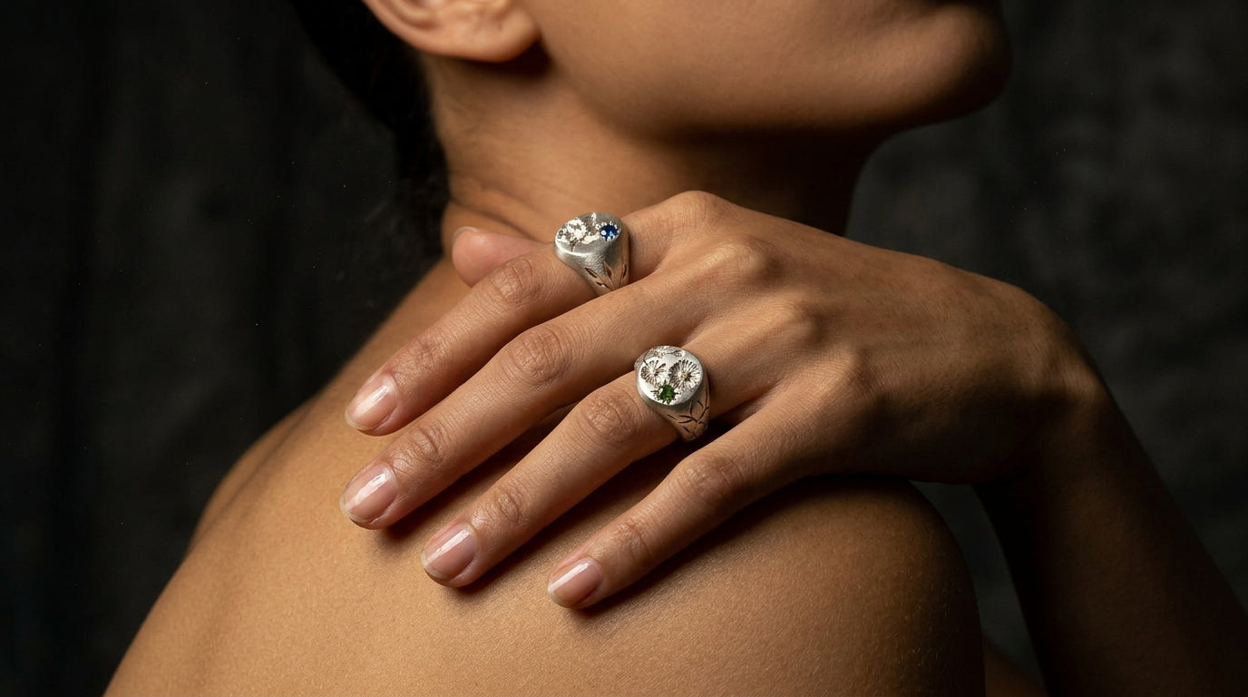 Hand engraved Narcissus and Cosmos signet rings in 940 Silver on hand by Mier Theo