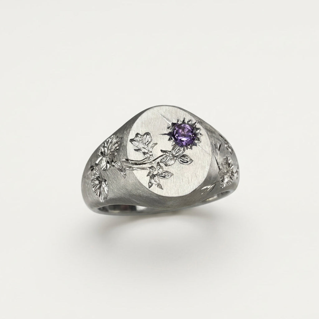 Hand engraved Violet signet ring in 940 Silver. Angled view. Engraved by Mier Theo
